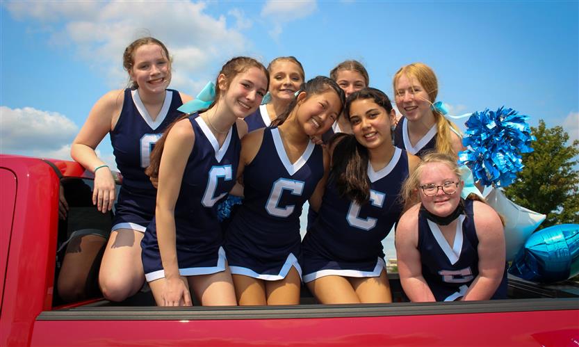 Students celebrate while on a homecoming parade float